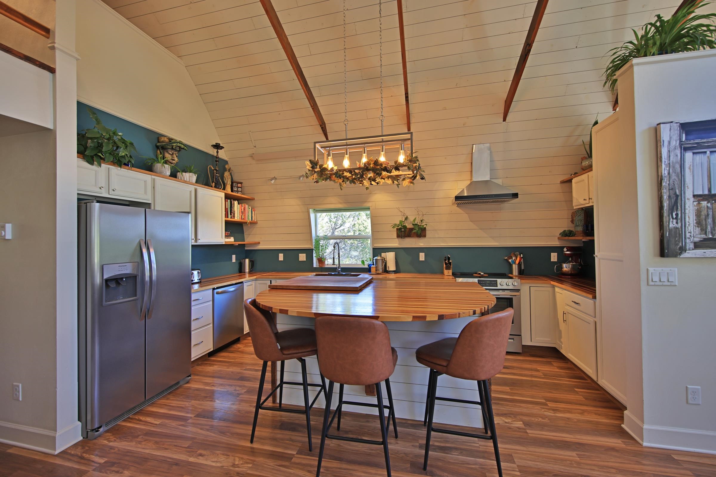 57191 Me Road Collbran, CO 81624 - Photo 15 of 42 a dining room with stainless steel appliances kitchen island granite countertop furniture and wooden floor