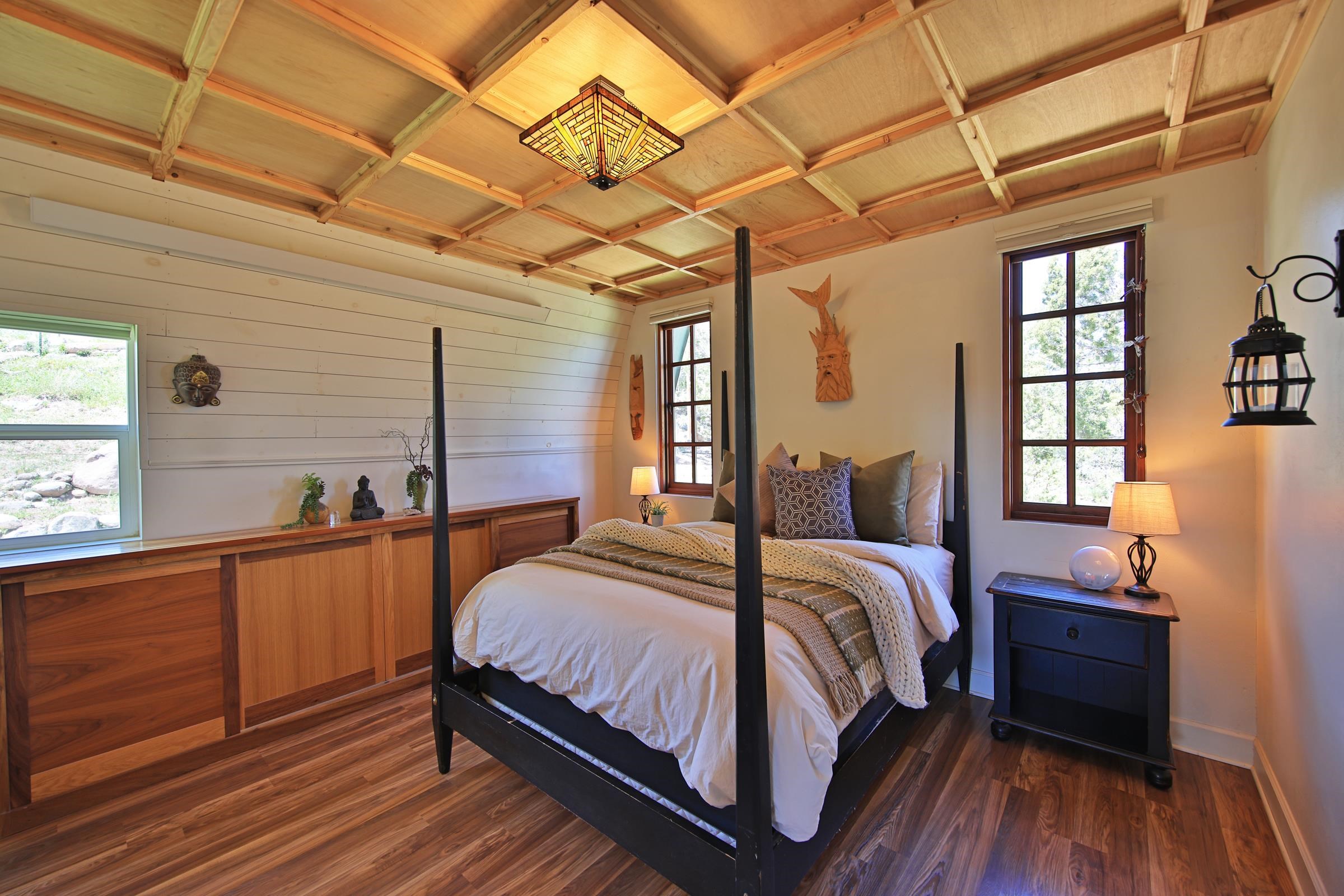 57191 Me Road Collbran, CO 81624 - Photo 19 of 42 a bedroom with a bed and wooden floor