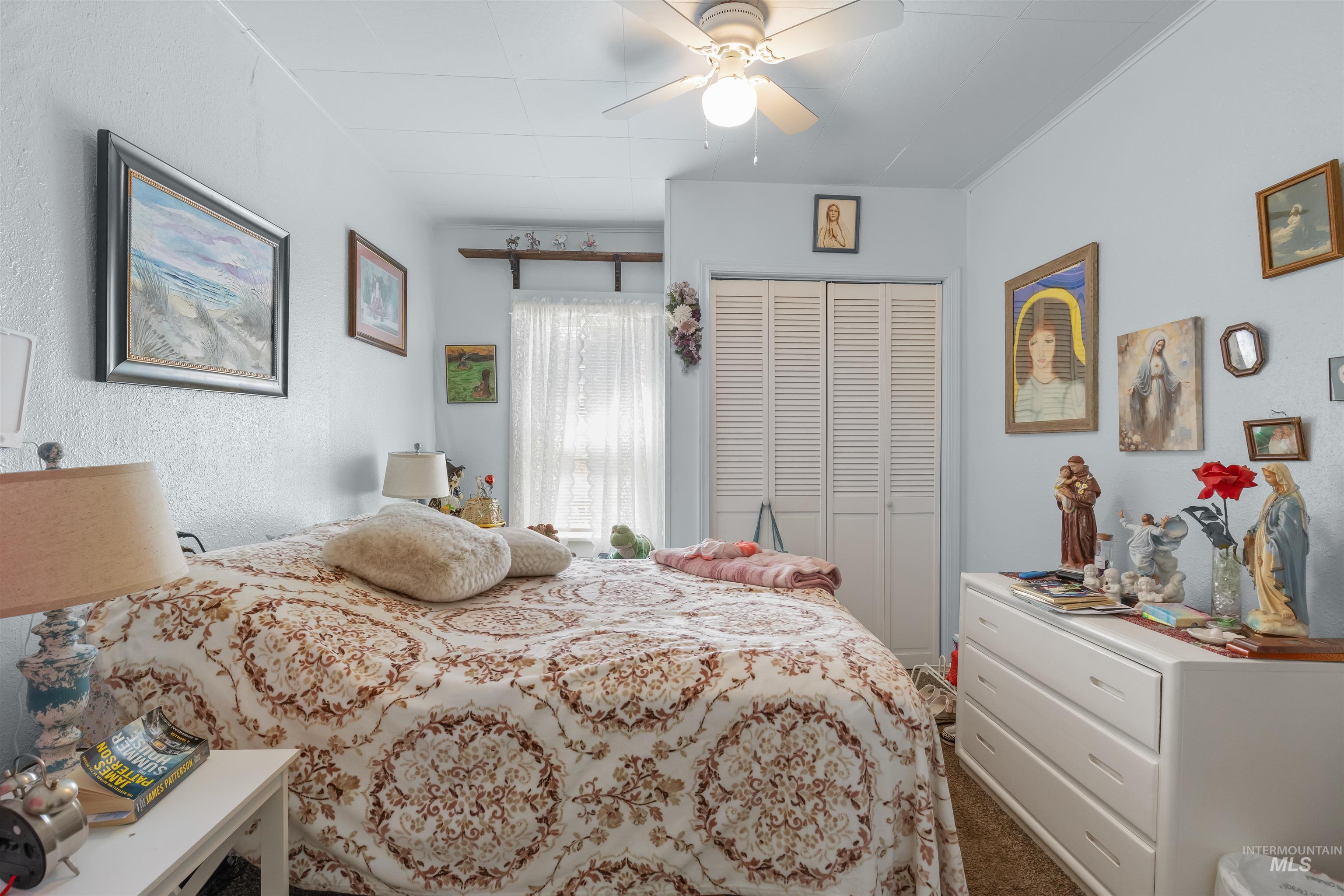 238 Hillcrest Road Lewiston, ID 83501 - Photo 25 of 27 Bedroom featuring light blue walls, a white ceiling fan, and white louvered bifold closet doors