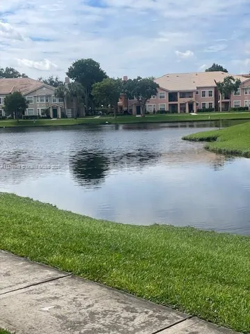 a view of a lake with houses in the background
