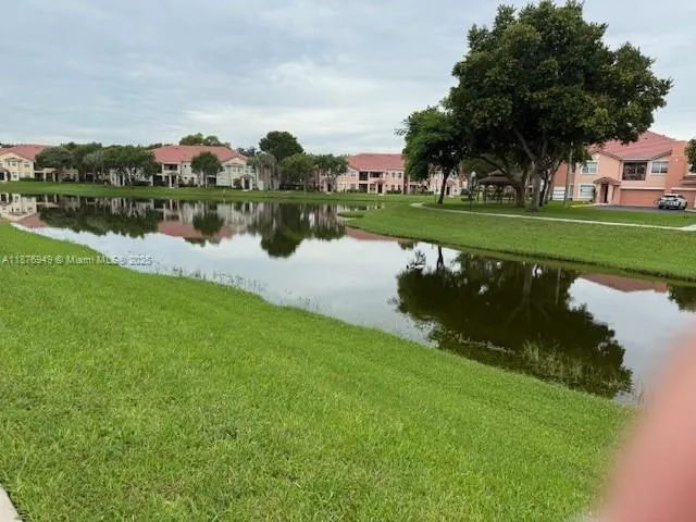 a view of a lake with houses in the background