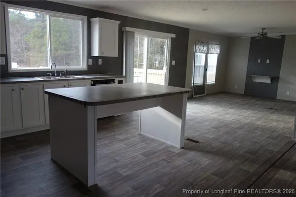 a kitchen with a sink and large window