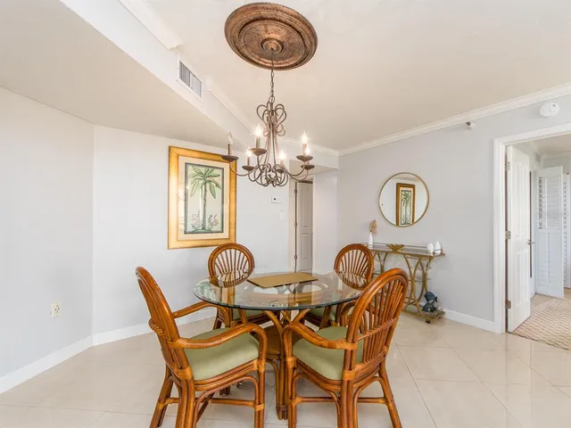 a dining room with furniture and a chandelier