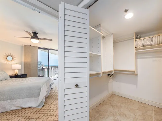 a view of a bedroom with closet and windows