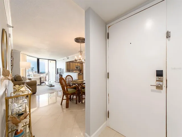a dining room with furniture and a floor to ceiling window