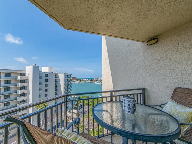 a view of a balcony and dining room