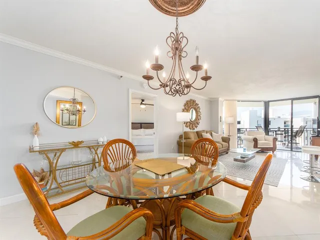 a view of a dining room with furniture and a chandelier