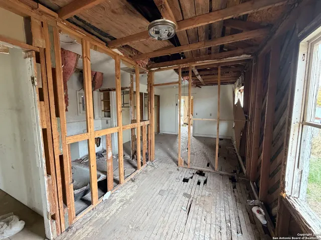 a view of an entryway with wooden floor and door