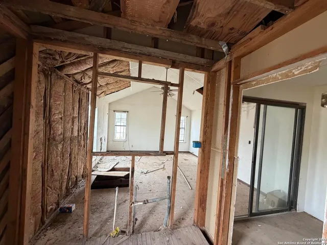 a view of a porch with a table and chairs