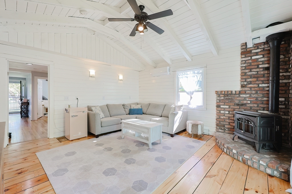 321 Shears Street Wrentham, MA 02093 - Photo 12 of 39 a living room with furniture a fireplace and a counter top space