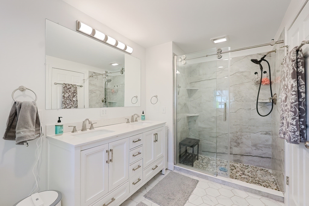 321 Shears Street Wrentham, MA 02093 - Photo 22 of 39 a bathroom with a granite countertop sink a toilet a shower and a mirror