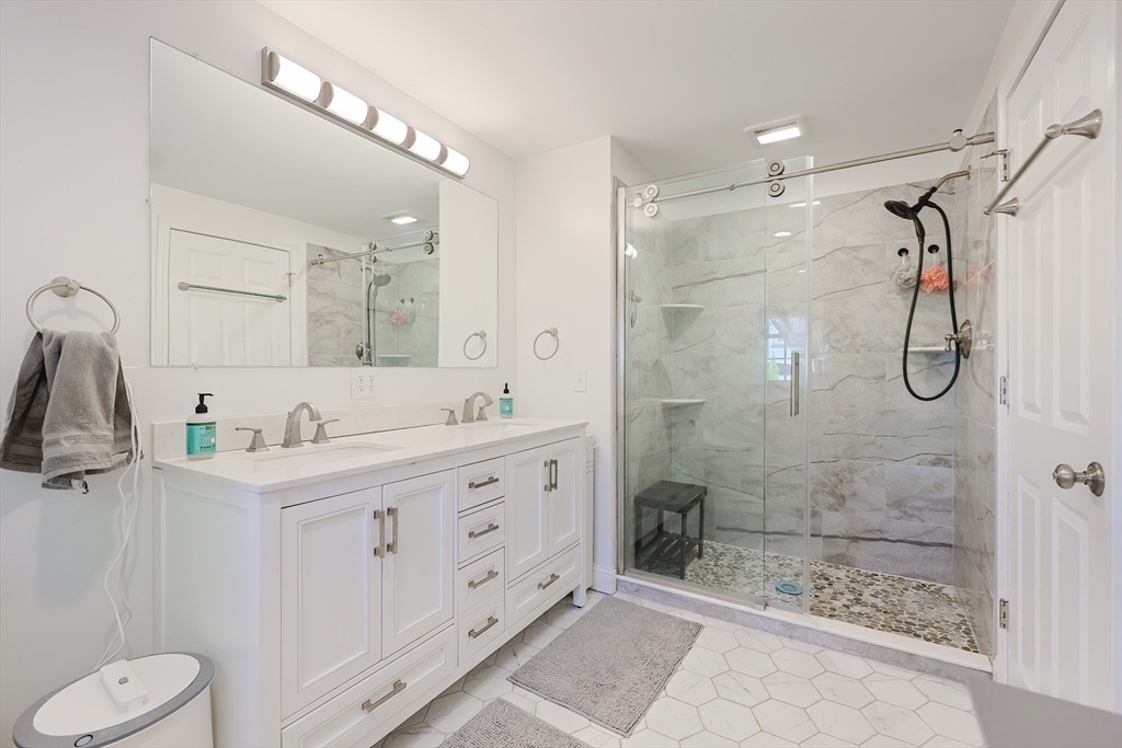 321 Shears Street Wrentham, MA 02093 - Photo 23 of 39 a bathroom with a shower sink and mirror