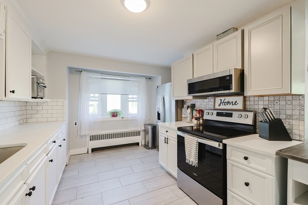 321 Shears Street Wrentham, MA 02093 - Photo 8 of 39 a kitchen with white cabinets and appliances