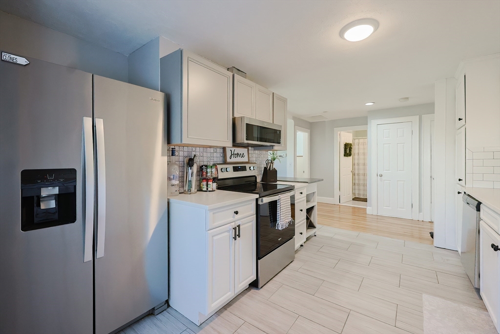 321 Shears Street Wrentham, MA 02093 - Photo 9 of 39 a kitchen with stainless steel appliances granite countertop a refrigerator and a stove top oven