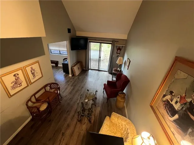 a view of a living room with furniture and gym equipment