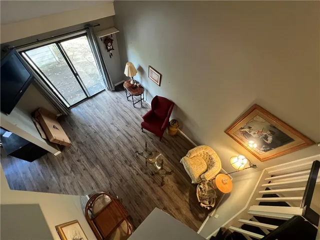 a living room with chairs and a fireplace