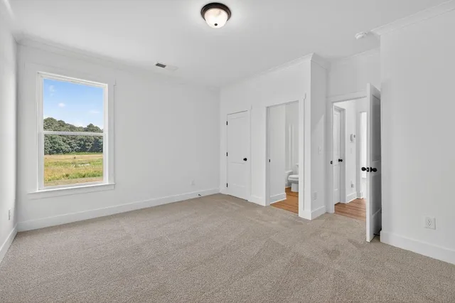 an empty room with a window and a hallway
