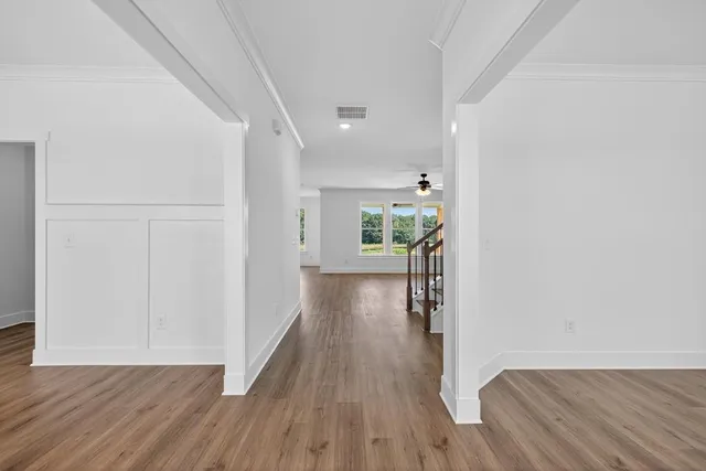 a view of hallway with wooden floor