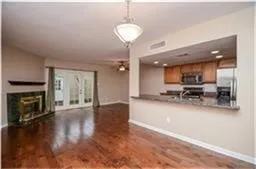 a view of a livingroom with furniture a fireplace and wooden floor