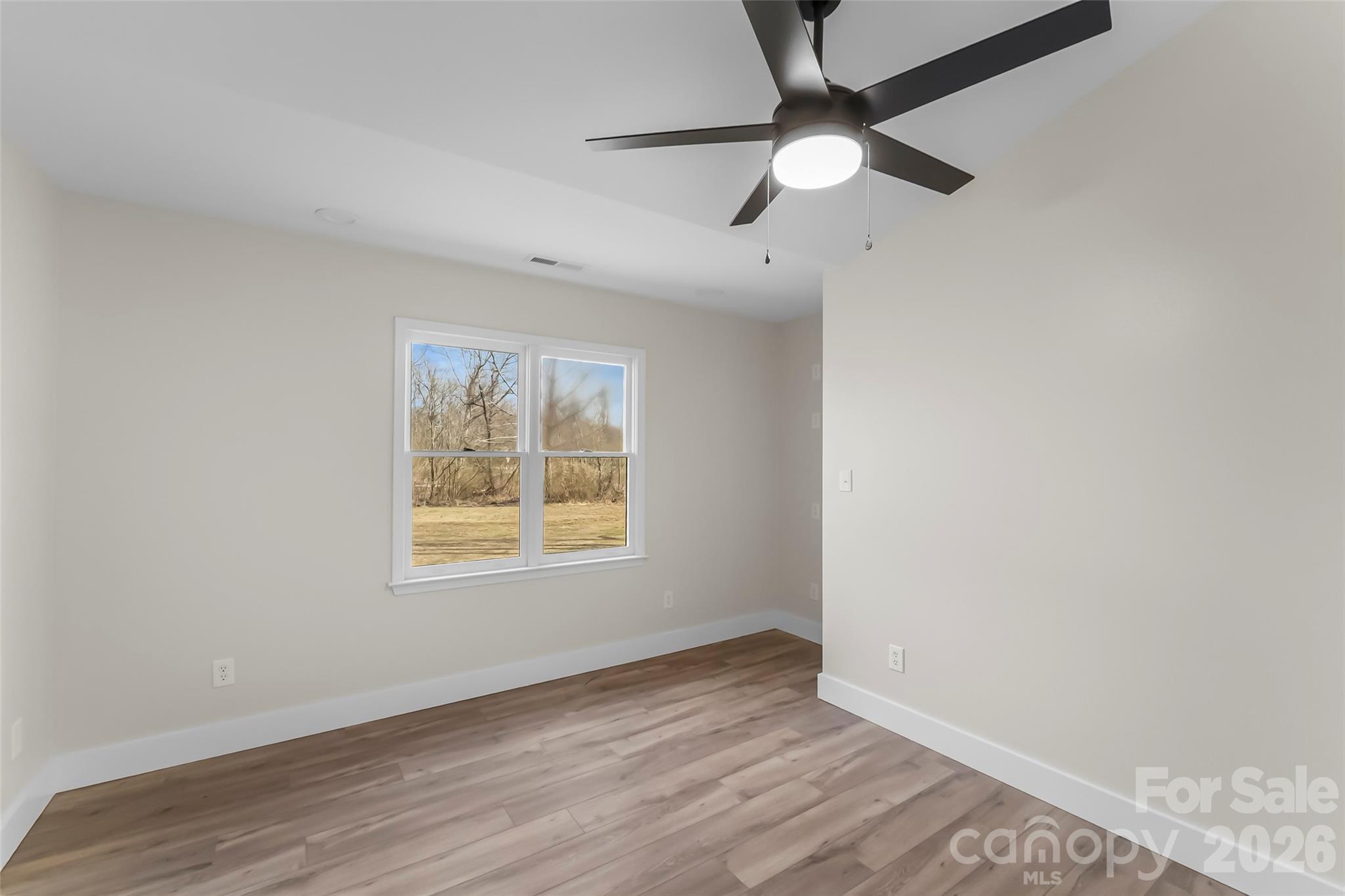 99 Hawkins Road Marion, NC 28752 - Photo 25 of 39 an empty room with wooden floor fan and windows