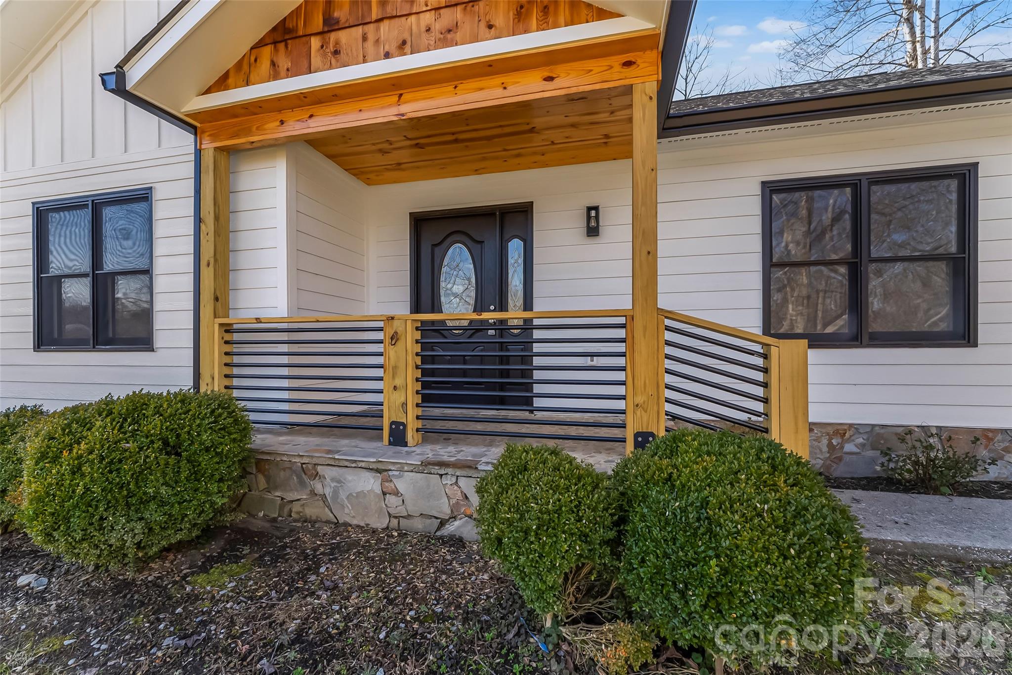 99 Hawkins Road Marion, NC 28752 - Photo 3 of 39 a view of a house with large windows and a small yard