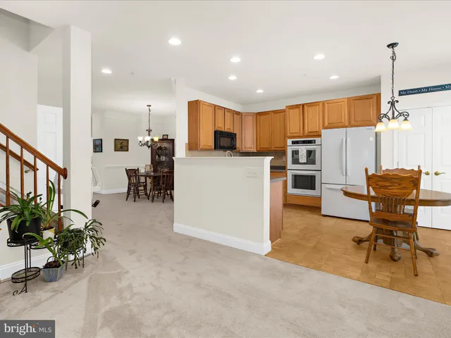 a living room with furniture and kitchen view
