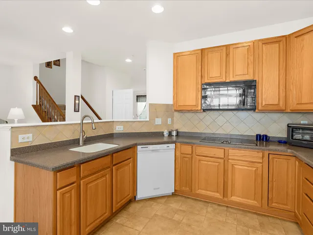 a kitchen with stainless steel appliances granite countertop a sink and cabinets