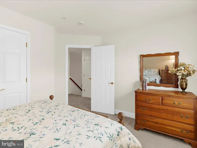 a bedroom with a bed and a dresser in it