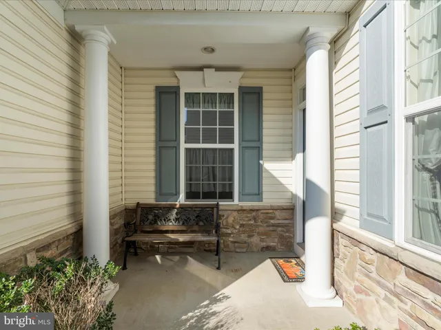 a bench is sitting in front of a house