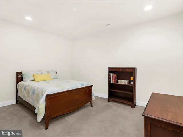 a bedroom with a bed and table