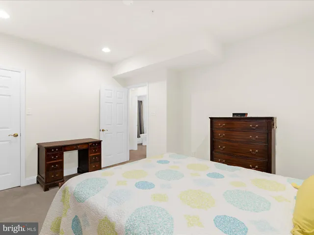 a bedroom with a bed and a dresser