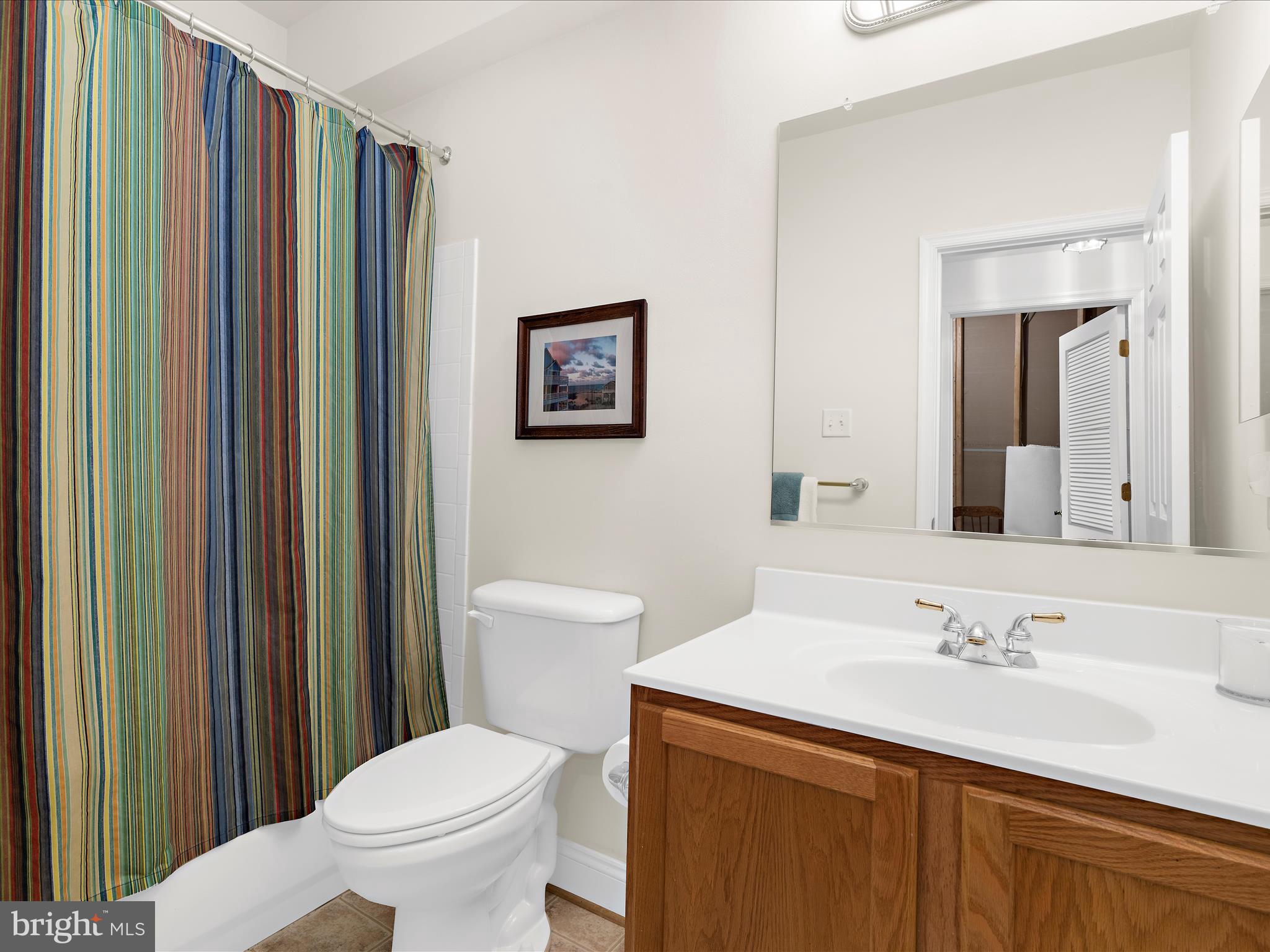7659 Porcelain Tile Court Odenton, MD 21113 - Photo 33 of 49 a bathroom with a sink a toilet and mirror