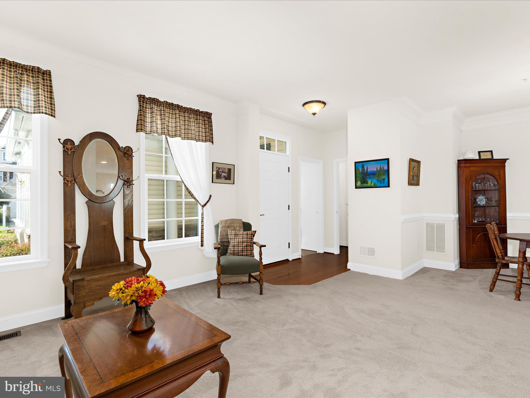 7659 Porcelain Tile Court Odenton, MD 21113 - Photo 4 of 49 a living room with furniture and a clock