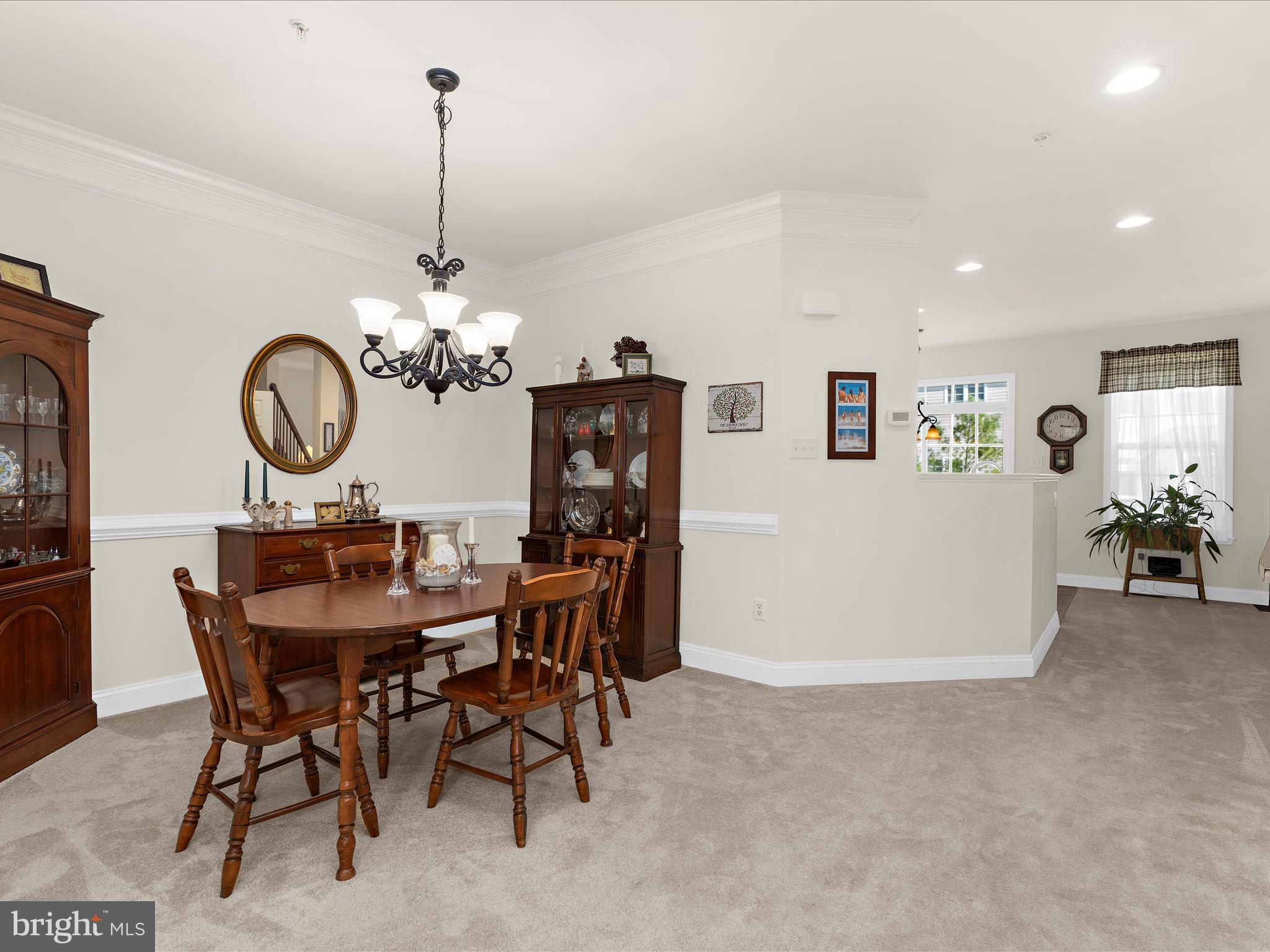 7659 Porcelain Tile Court Odenton, MD 21113 - Photo 7 of 49 a view of a dining room with furniture and chandelier