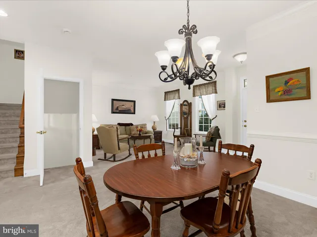 a view of a dining room with furniture and chandelier
