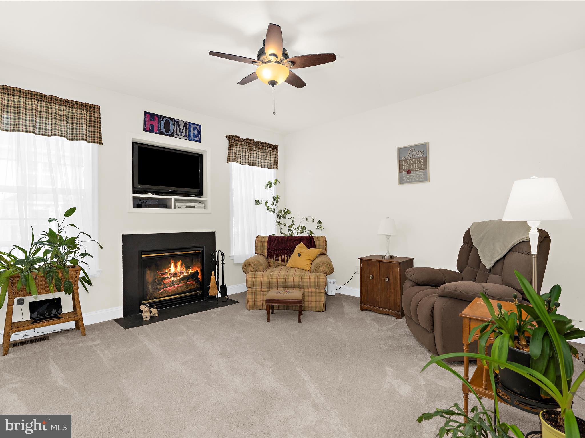 7659 Porcelain Tile Court Odenton, MD 21113 - Photo 10 of 49 a living room with furniture a flat screen tv and a fireplace