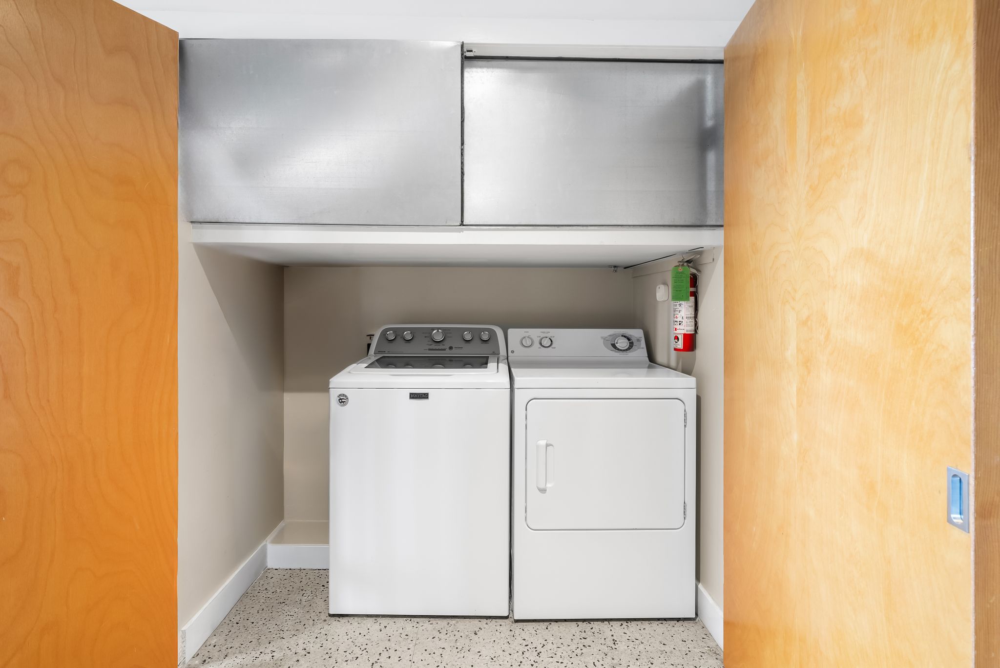 710 Colorado Street, Unit 6E Austin, TX 78701 - Photo 13 of 24 Conveniently located laundry space includes essential washer and dryer units for daily chores.