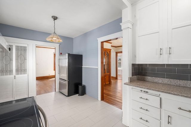 a kitchen with a refrigerator and a sink