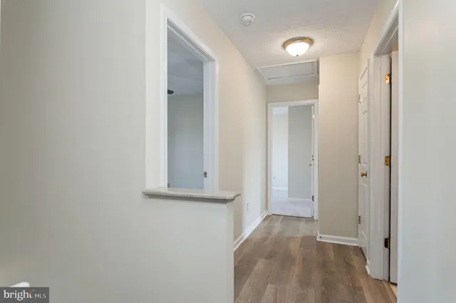 a view of hallway with wooden floor