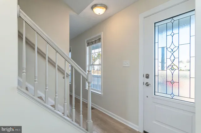 a view of an entryway with wooden floor and windows