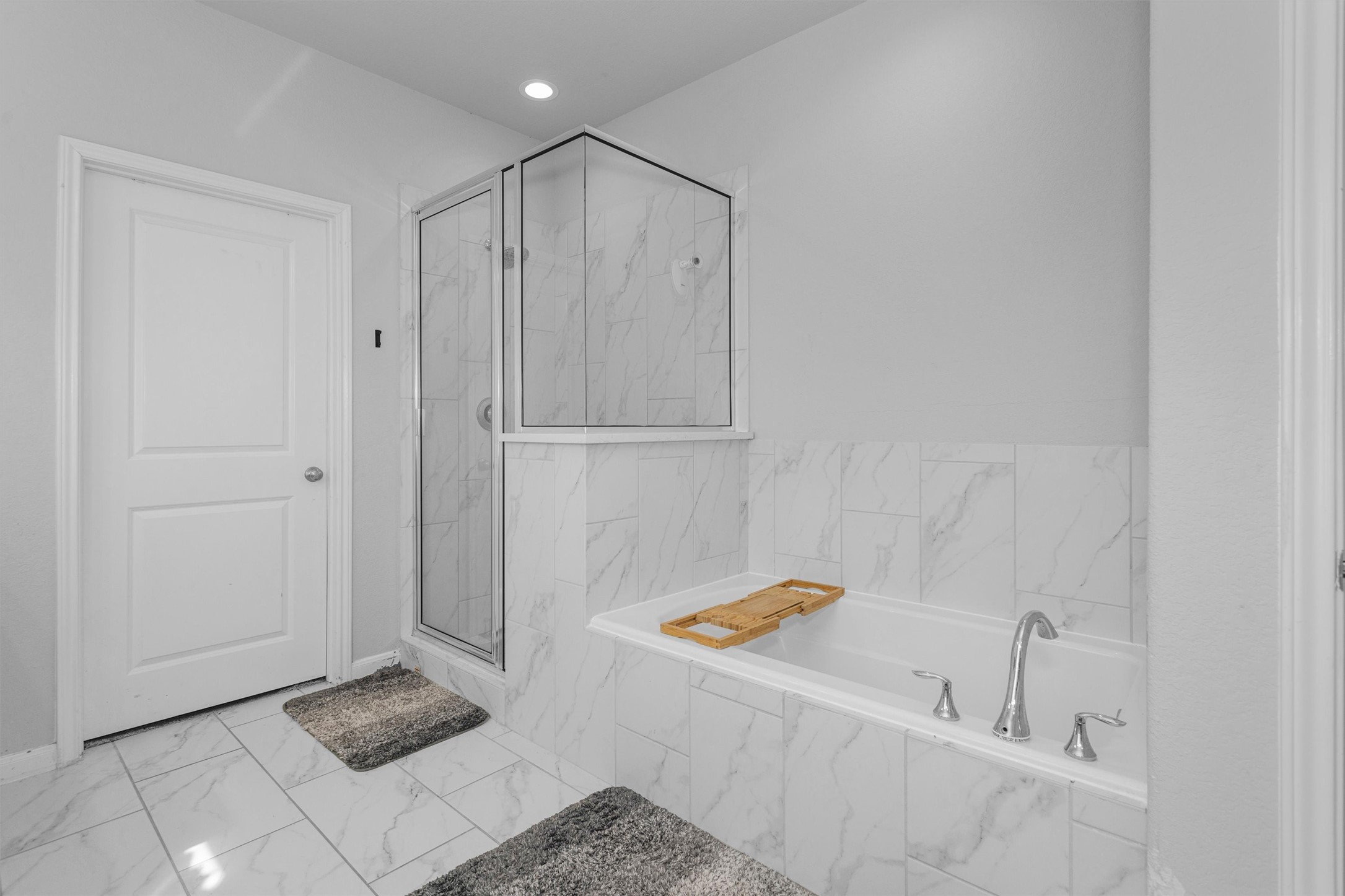 2375 Hagerman Road Conroe, TX 77384 - Photo 21 of 35 Primary offers walk in shower, soaking tub and look at those pretty tile floors.