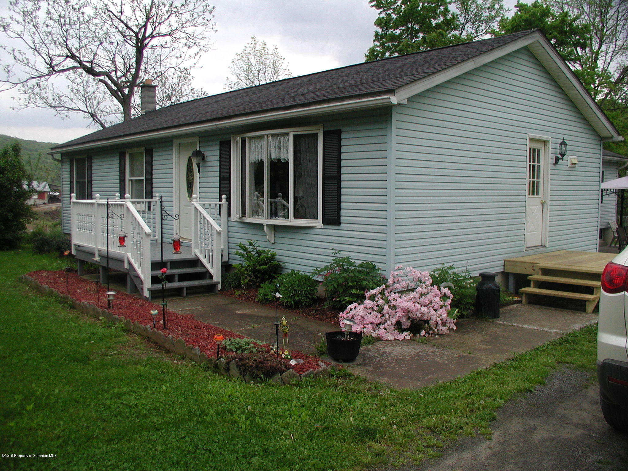 94 Depot Road Kingsley, PA 18826 - Photo 1 of 27 a view of a house with a yard and a garden
