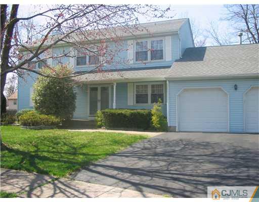 6 Sinclair Road Edison, NJ 08820 - Photo 2 of 14 a front view of a house with a yard and garage