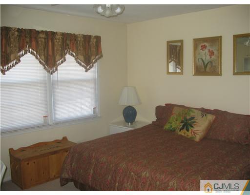 6 Sinclair Road Edison, NJ 08820 - Photo 11 of 14 a bedroom with a bed and painting on the wall