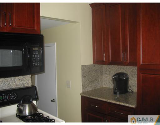 6 Sinclair Road Edison, NJ 08820 - Photo 7 of 14 a kitchen with a sink and cabinets