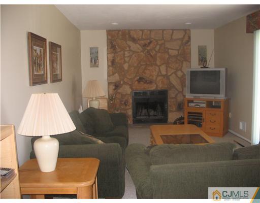 6 Sinclair Road Edison, NJ 08820 - Photo 8 of 14 a living room with furniture a flat screen tv and a fireplace