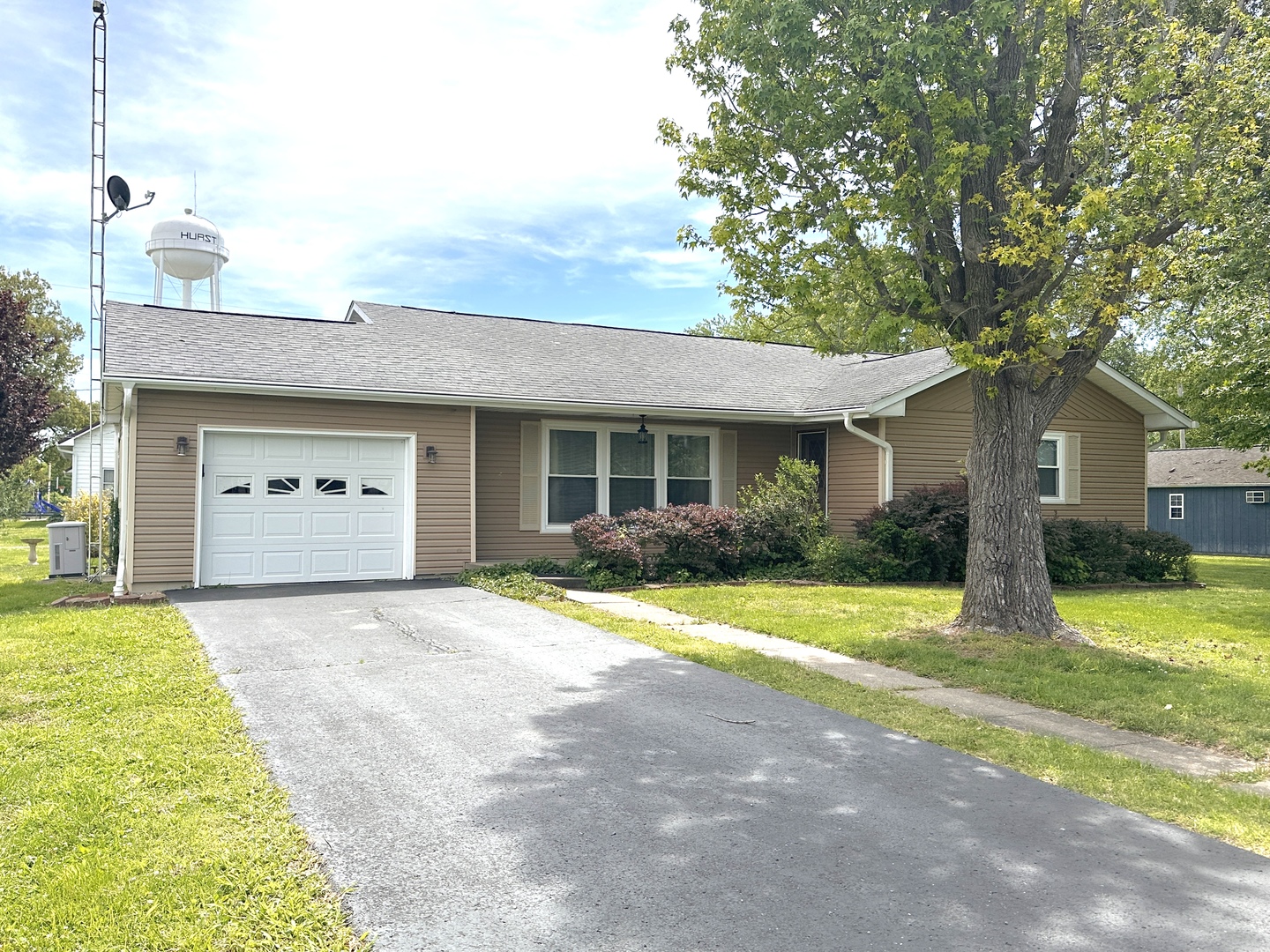 106 George Street Hurst, IL 62949 - Photo 1 of 14 a front view of a house with a yard and garage