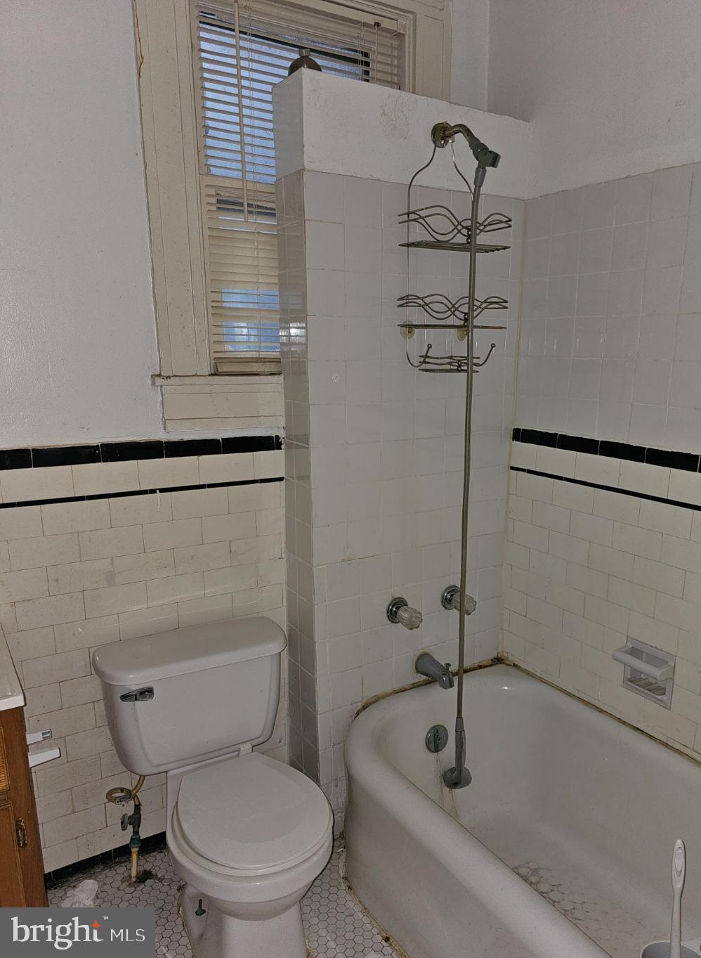 3239 Dudley Avenue Baltimore, MD 21213 - Photo 22 of 31 a white toilet sitting next to a bath tub