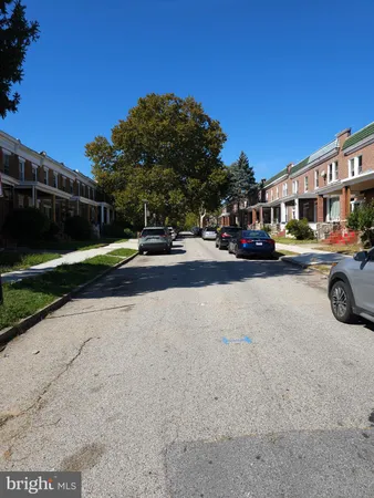 a view of a street with a cars parked in front of it