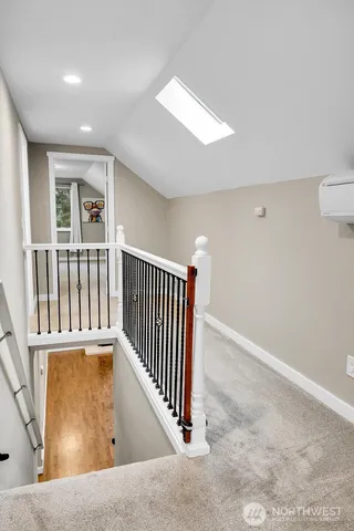 an entryway with wooden floor and windows